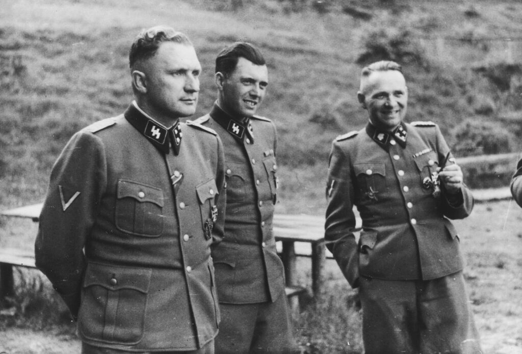 SS in Auschwitz at Solahütte in 1944: Richard Baer, Josef Mengele, Rudolf Höss. Public domain.
